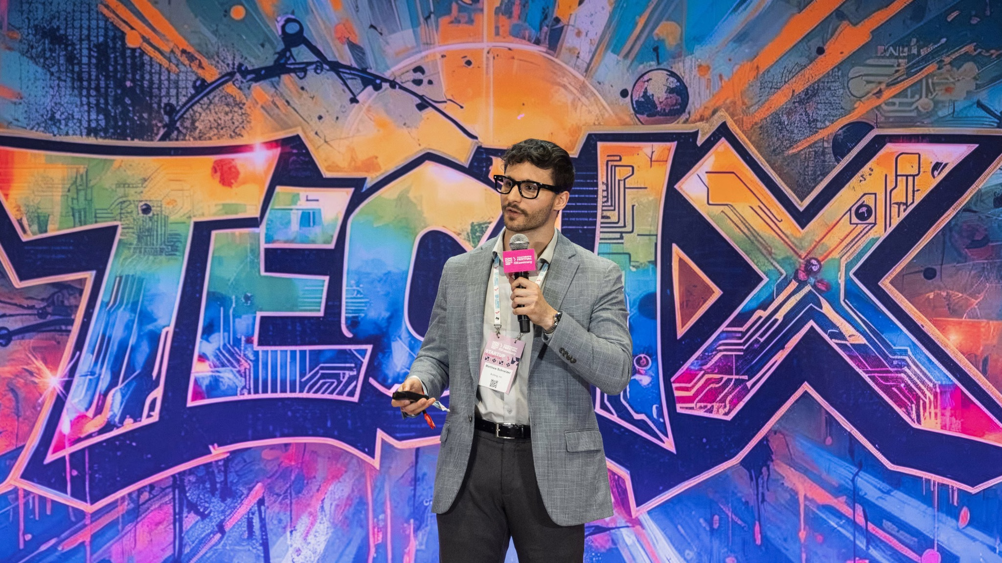 Matthew A. Schneider speaking on stage at Hong Kong FinTech Week