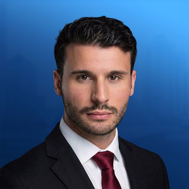 Matthew A. Schneider — Headshot — blue background